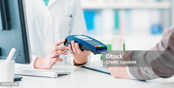 Man Purchasing Products In The Pharmacy Stock Photo - Download Image Now - Paying, Credit Card, Doctor