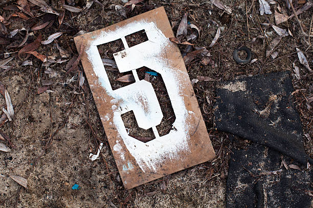 Number five on the old metal stencil on the ground.