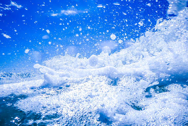 istock blue crystal water waves crashing on beach 613227764