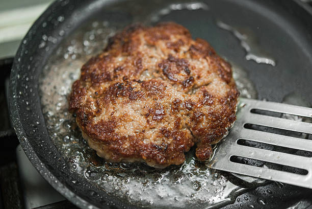 istock burger cutlet on metal pan 613228584