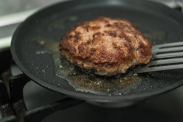 istock burger cutlet on metal pan 613228648
