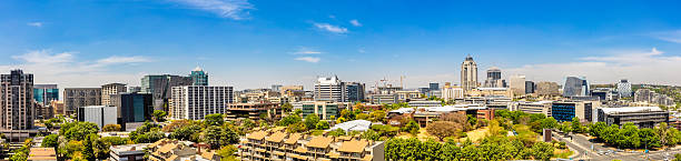 Large Sandton City Panorama with new development construction. Sandton has become home to most of the major financial, consulting and banking firms in South Africa. It houses approximately 300 000 residents and 10 000 businesses, including investment banks, top businesses, financial consultants, the Johannesburg stock exchange and one of the biggest convention centres on the African continent, the Sandton Convention Centre.
