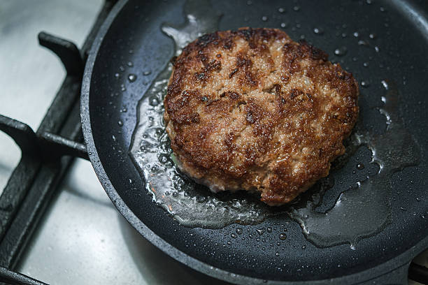 istock burger cutlet on metal pan 613228674