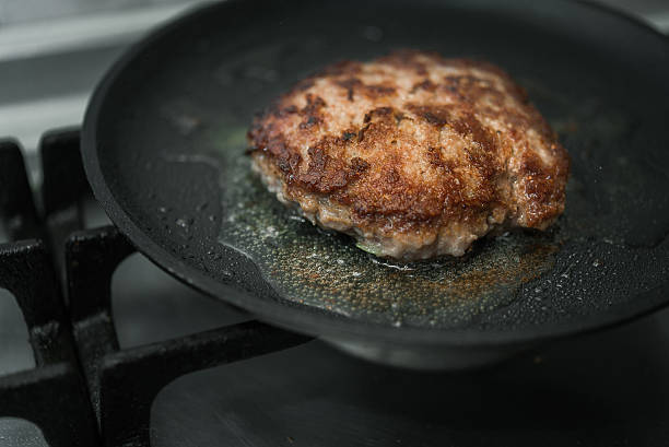 istock burger cutlet on metal pan 613228798