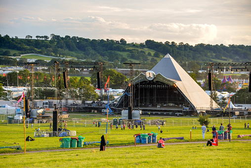 Pilton, United Kingdom - June 23, 2015 : A view of the Pyramid stage as people arrive at the Glastonbury festival 2015.