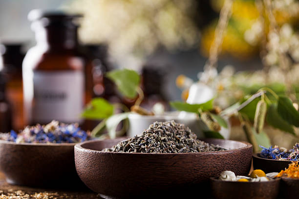 istock Medicine bottles and herbs background 613229334