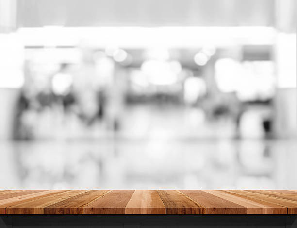 istock Empty wooden table and blurred shoppping mall bokeh light backgr 613230634
