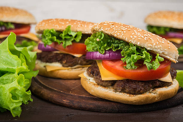 istock burgers on wooden table 613233070