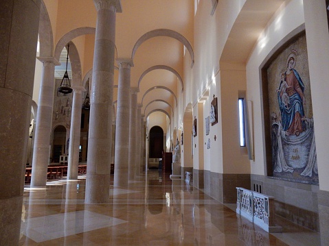 Benevento, Campania, Italy - September 30, 2016: the aisles of the cathedral after the restoration works were completed in December 2012. Dating back originally to the seventh century and remodeled several times over the centuries, was completely destroyed by Allied bombing in September 1943, a few days after the armistice, and rebuilt in its present form. They were saved only the facade and the bell tower, dating from the late thirteenth century. At the bottom you can see the entrance to the archaeological trail, built after the Roman original plant discovered during the recent restoration works, and is currently open to the public for only 2 €.