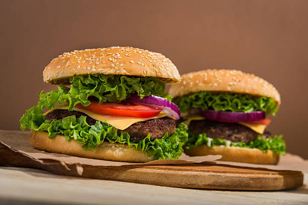 istock burgers on wooden table 613233660