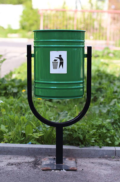iron green trashcan on the street, summertime