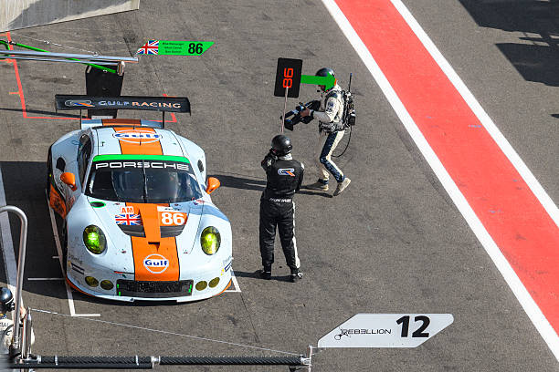 Spa, Belgium - May 7, 2016: Gulf Racing Porsche 911 RSR GTE pit stop in the pitlane during the 2016 FIA WEC 6 Hours of Spa. Mechanics ar re-fuelling the car and getting ready to change the tyres. The car is driving around the Spa Francorchamps race track during the WEC 6 Hours of Spa-Francorchamps. The team participates in the 2016 FIA World Endurance Championship (WEC).