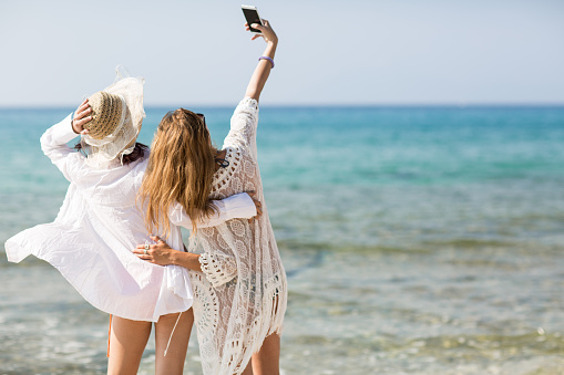 Sisters on the beach taking a selfie