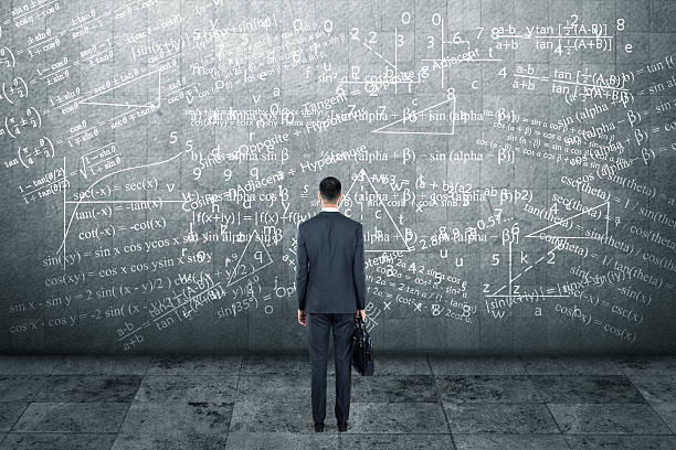 istock Thoughtful businessman standing in front of wall 613235066