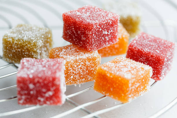 Fruit cube jelly candy Fruit cube jelly candy on cake rack gummy candy stock pictures, royalty-free photos & images