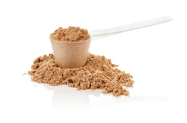 Product photograph of scoop of whey protein with visible texture and mirror reflection