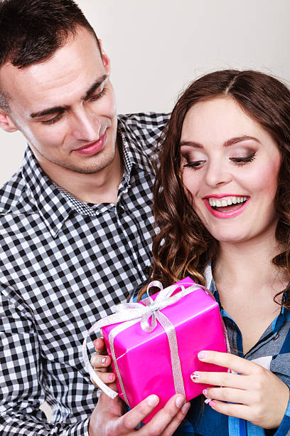 istock happy romantic couple with gift 613236936