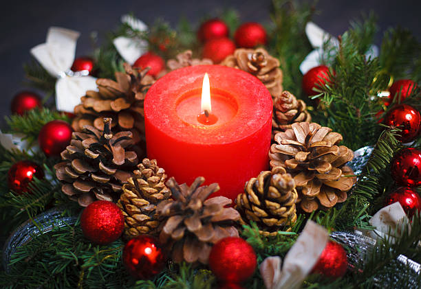 istock Decorated Christmas wreath with a candle close-up 613237682