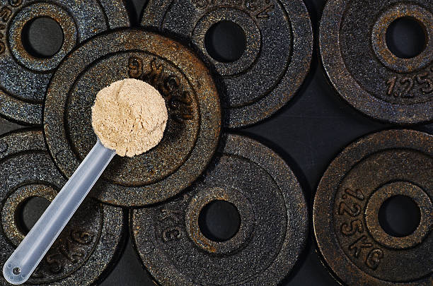 istock Scoop of whey protein on black background. Top view 613238326
