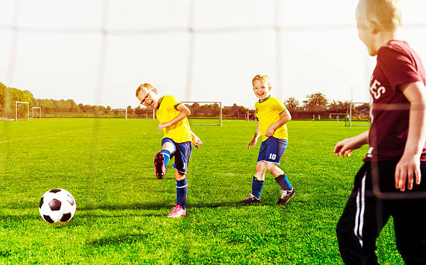 istock Soccer player shoots goal while playing with his football team 613238522