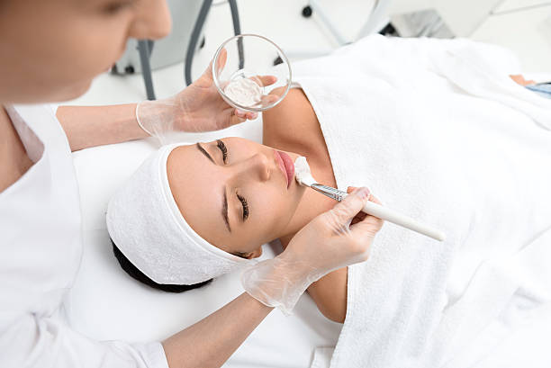 istock Professional beautician making facial treatment 613239146