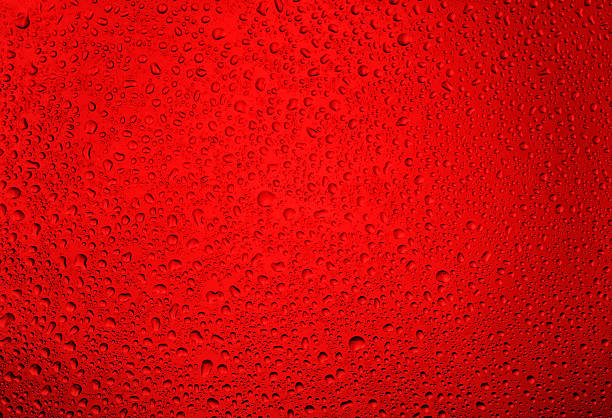 istock Water droplets on the glass with a red illumination 613239362