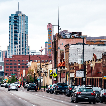 Denver, Colorado, USA - May 1, 2016: Traffic in the Arts District on Santa Fe near downtown. On the corner there is nearly 100-year-old Aztlan Theatre.