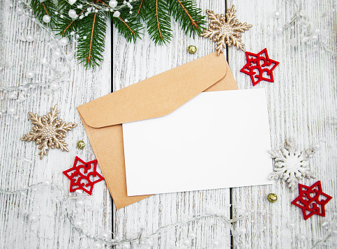 Envelope with christmas decoration on a old wooden board