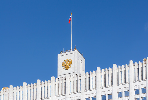 Fragment view of the Russian White House with flag and coat of arms