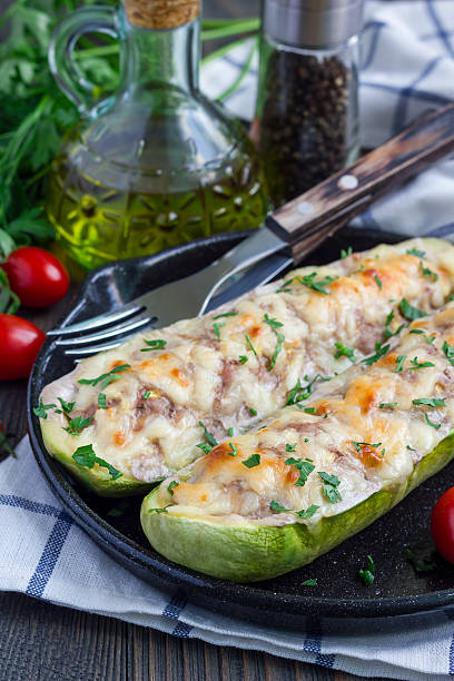 istock Zucchini boats stuffed with ground meet on cast iron pan 613241134
