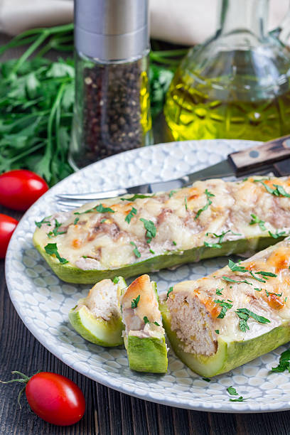 istock Zucchini boats stuffed with ground meet on a plate, vertical 613241146