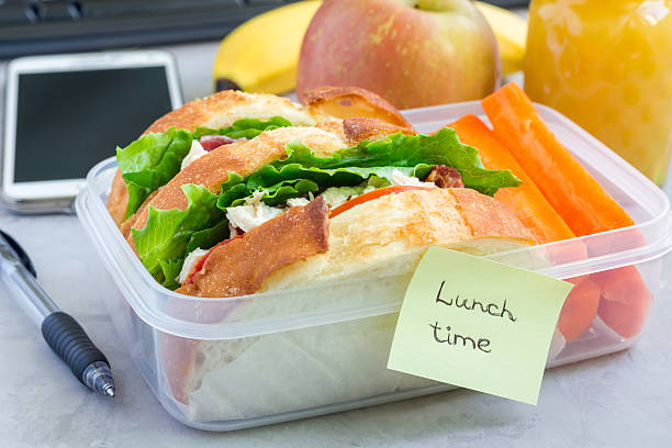 istock Lunch box with chicken salad sandwiches and carrot sticks, horizontal 613241300
