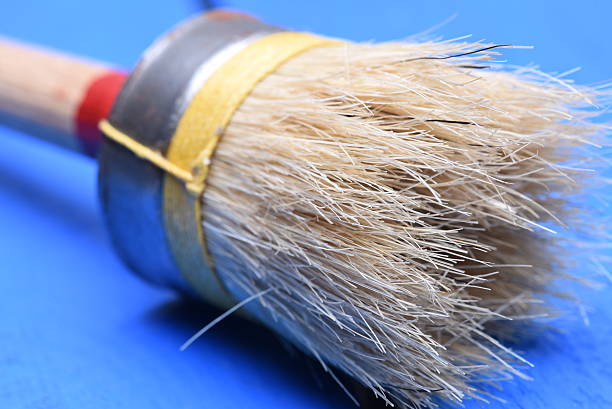 istock Paintbrush on wood background 613241630
