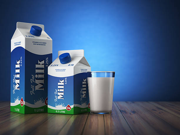Milk carton packand glass on blue background.