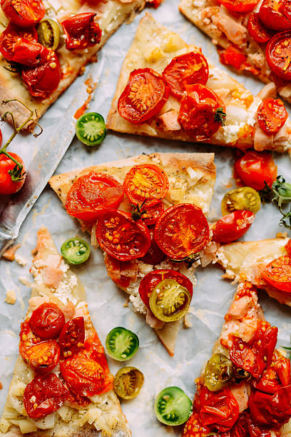 istock Pizza with tomatoes, shallot and fresh herbs. Cherry Tomato Wood 613247736