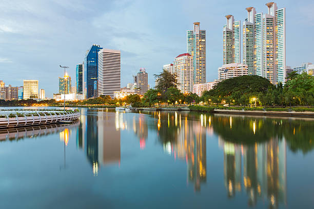 istock Reflection of Office building downtown in public park 613247874