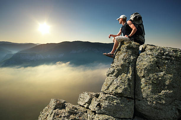 istock Man on peak of mountain 613248052