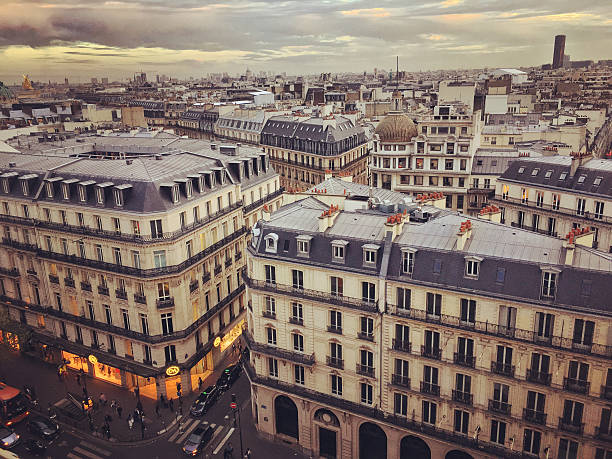 Paris, France  - September 26, 2016: Paris cityscape, France. View from above on Paris roofs, streets with people cars and shops. 