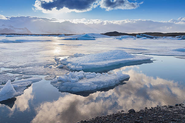 istock Beautiful winter natural lagoon with sky reflection 613250832