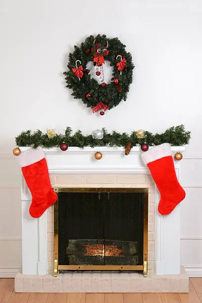 christmas fireplace with santa socks and wreath