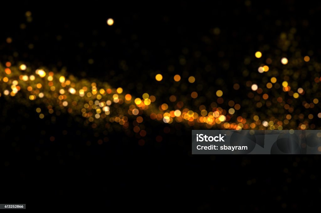 waving golden glitter Golden glitter waving on black background. Abstract Stock Photo