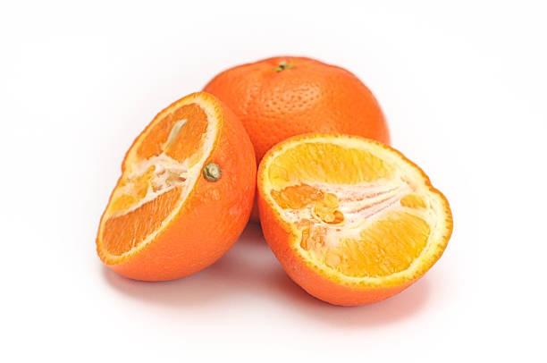 istock Oranges whole and sliced half fruits isolated on white background 613252946