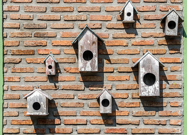 Wooden bird house on the brick wall