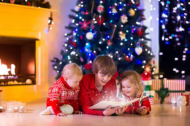 istock Kids playing at fireplace on Christmas eve 613253684