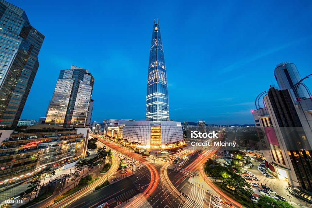 Cityscape Songpagu Skyscrapers Lotte World Tower at Night Seoul Cityscape of Songpagu district in Seoul at night. Motion blurred traffic lights, illuminated skyscrapers and Lotte world tower. Seoul, South Korea, Asia. Aerial view with 10 mm ultra wide angle 42 MP Sony A7RII. Seoul Stock Photo