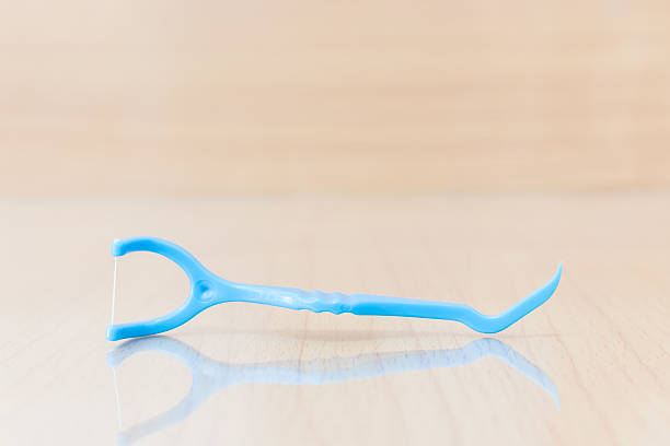 istock Oral Device : Dental flossers on wooden background 613255264