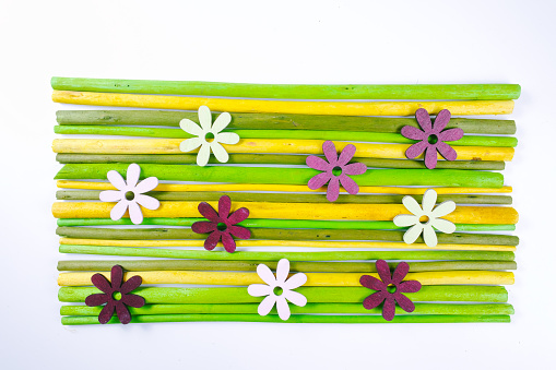 Decorative colorful wooden sticks with flowers background