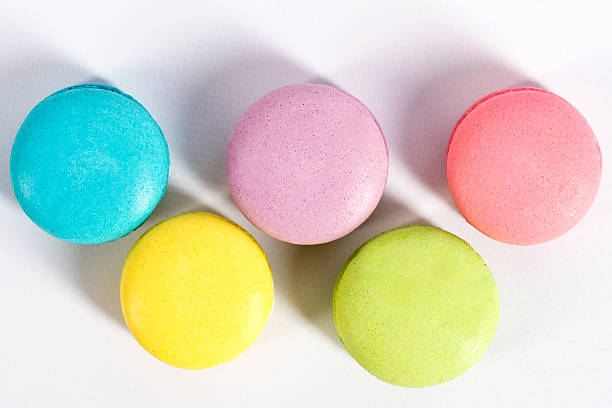 istock Collection of brightly colored French macarons on white background 613301952