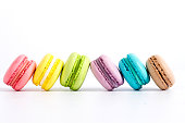 Collection of brightly colored French macarons on white background