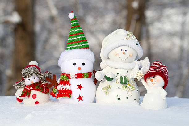 istock four snowmen on a snow stand in one row 613303014
